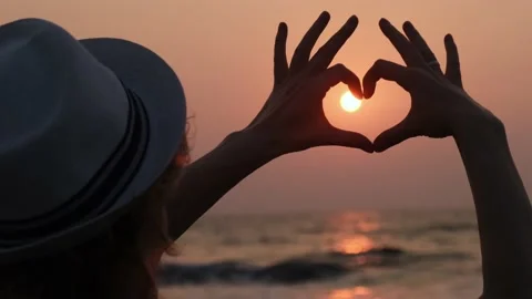 Heart shaped hands on sunset background. Stock Footage 229461804