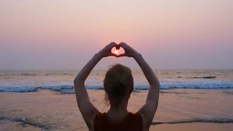 Heart shaped hands on sunset background. Stock Footage 238504183