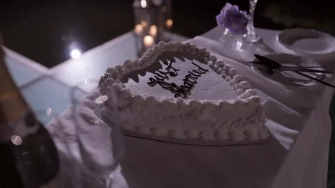 Heart Shaped Just Married Cake on a Candlelit Wedding Table at Night Stock Footage 344438189