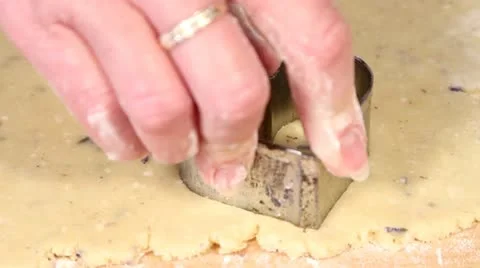 Heart-shaped lavender biscuits being cut out Stock Footage 24673345