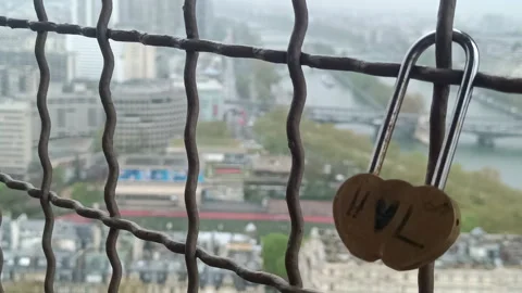 Heart-shaped love lock attached to a safety fence  view of Paris Stock Footage 336691837