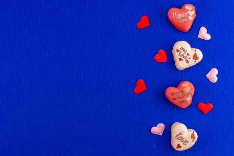 Heart shaped macarons on phantom classic blue color background. Stock Photos