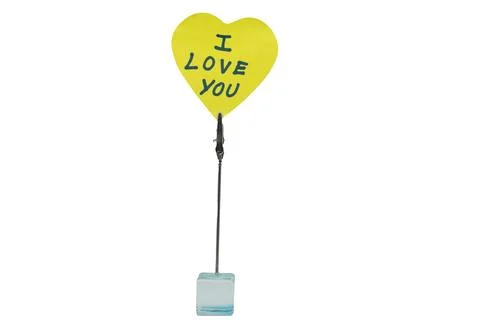 Heart-shaped note holder with a message of love displayed on a clear base Stock Photos