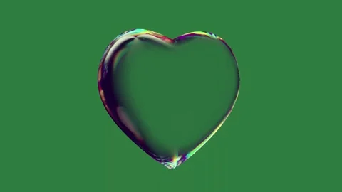 A heart shaped object on green background and screen an image of rainbow Stock Footage 335938122