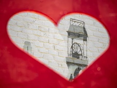 Heart-Shaped Opening with a view of a mining Tower on the wall Stock Photos
