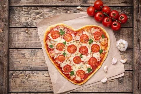 Heart shaped pizza margherita love food symbol with mozzarella, tomatoes Stock Photos