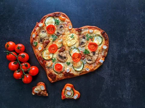 Heart shaped pizza for Valentine's Day. food concept of romantic love Stock Photos