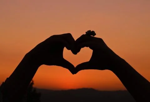 Heart-shaped silhouette hands. Stock Photos