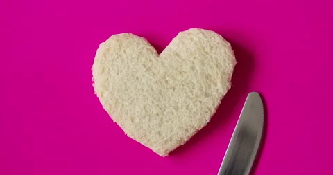 Heart-shaped slice of bread. Romantic breakfast on Valentine's Day. Stock Footage 146919043