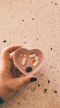 Heart-shaped supplements Stock Photos