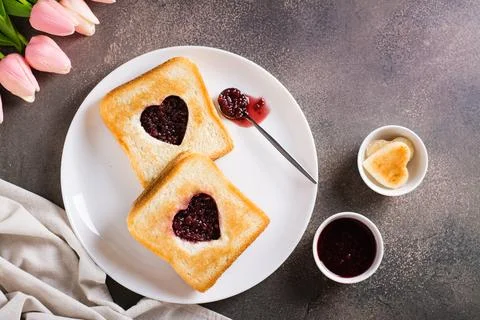 Heart shaped toast with raspberry jam on a plate. Food for lovers. Top view Stock Photos