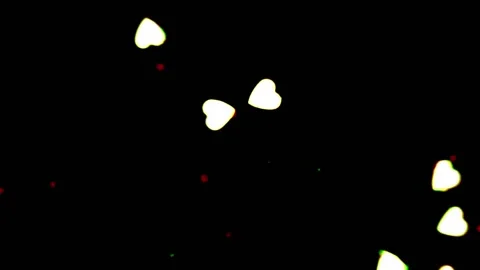 Heart shapes floating acros the frame with a black background Stock Footage 133506884