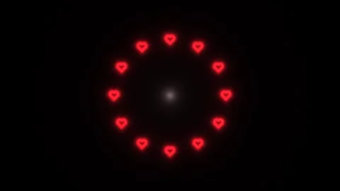 Heart shapes glowing in a circular pattern on a dark Stock Footage 339009171