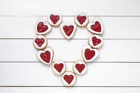 Heart of the shortbread heart-shaped cookies with jam on white wooden table Stock Photos
