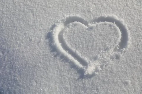 Heart on snow Stock Photos