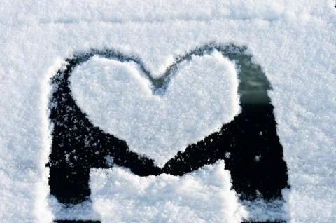 Heart on snowy window Stock Photos