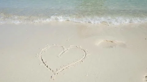 Heart symbol on the sand beach cleared by sea waves. Stock Footage 59774986