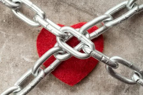 Heart tied with chains Stock Photos