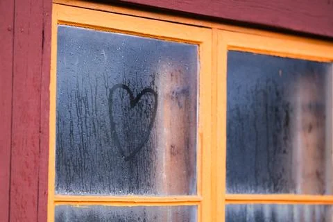 A heart on a wet window Stock Photos