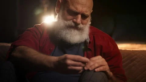 Heartbroken bearded man holds wedding ring, facing loneliness after loss Stock Footage 346714252