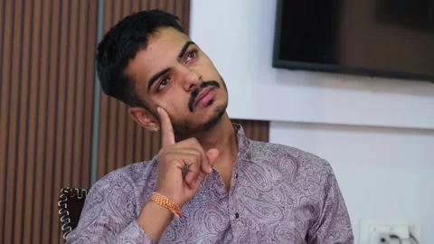 Heartbroken Young Man Sitting in Deep Thought Видео 330738427