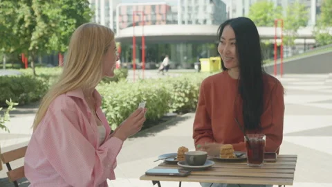 Heartfelt Gift Exchange Between Close Friends At Outdoor Cafe 스톡 동영상 313843346