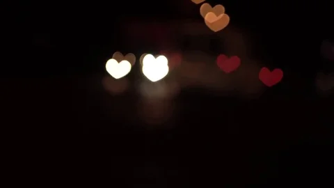 Hearth shaped bokeh of car lights at night. Stock Footage 80723644