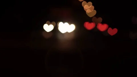 Hearth shaped bokeh of car lights at night. Stock Footage 80959340
