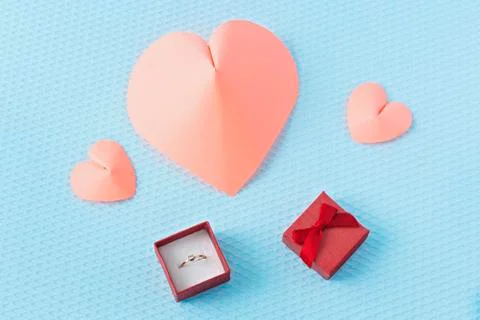 Hearts and ring on a blue background. Valentine's Day. Valentines day greetin Stock Photos