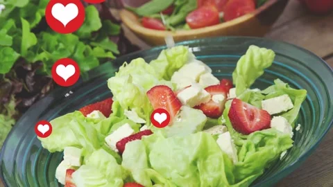 Hearts appearing along left edge floating inward and dressing pouring onto green Stock Footage 333950377