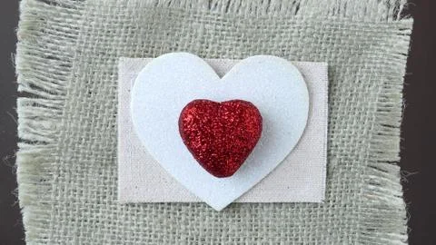 Hearts with burlap on silver background Stock Photos