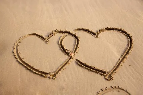 Hearts designed on sand. Stock Photos