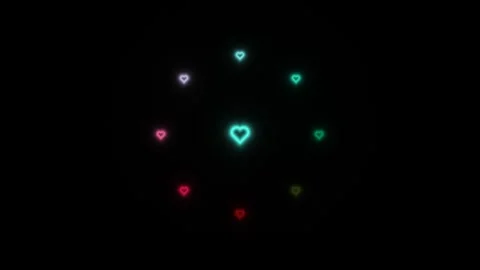 Hearts in different colors circle in a pattern on a dark Stock Footage 338323304