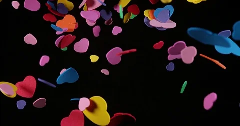 Hearts falling against Black Background for Saint Valentine's Day, Slow Motion Stock Footage 75971652