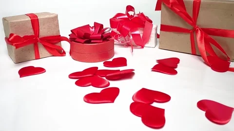 Hearts falling in slow motion and gift boxes Stock Footage 166628504