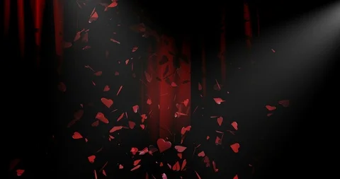 HEARTS floating down on a lit stage. Red curtains in background Stock Footage 89481547