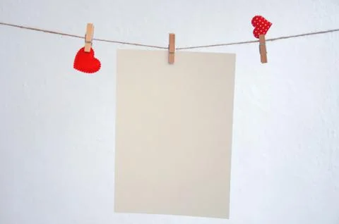 Hearts hang on clothespins on a white background..Nick with hearts hanging on Stock Photos