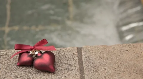 Hearts lie by the pool on a granite stone. Stock Footage 48564281