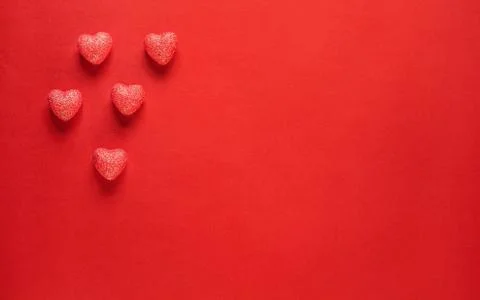 Hearts on red background. Stock Photos