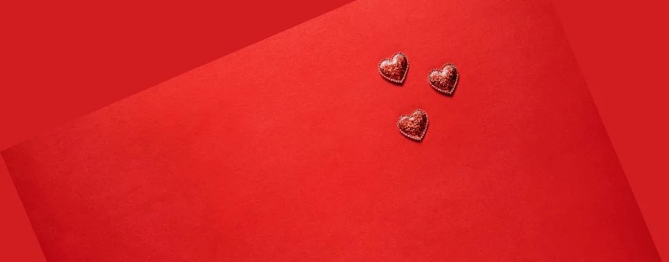 Hearts on red background. Stock Photos