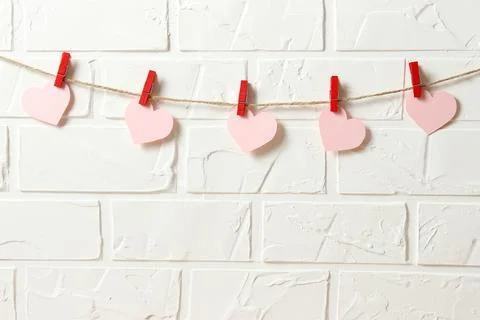 Hearts on a thread on a colored background. Stock Photos