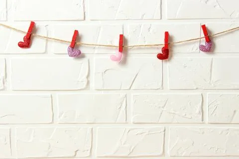 Hearts on a thread on a colored background. Stockfoto's