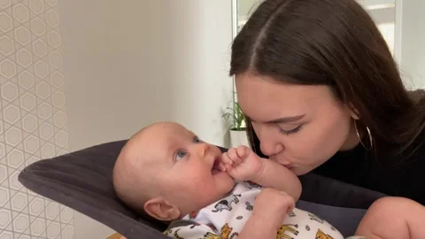 A Heartwarming Caring Moment Shared Between a Loving Mother and Her Baby in a Stock Footage 304731172