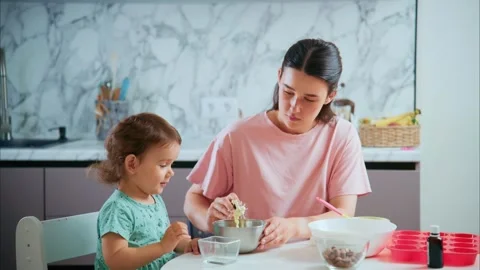 A Heartwarming Moment of Connection: A Parent and Child Bonding Over Baking in a Stock Footage 315931663