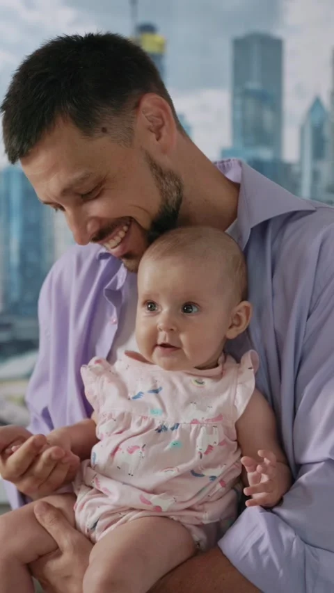 A Heartwarming Tender Moment Between a Father and His Baby in a Vibrant Urban Stock Footage 314360048