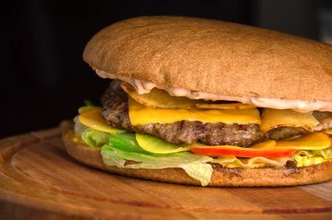A hearty cheeseburger with beef chops Stock Photos