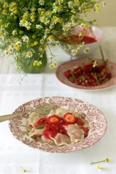 A hearty homemade breakfast or lunch - dumpling or vareniki with strawberries Stock Photos