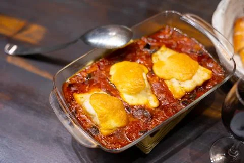Hearty lunch, cooked xanfaina cod with seasonal vegetables in baking dish. Stock Photos
