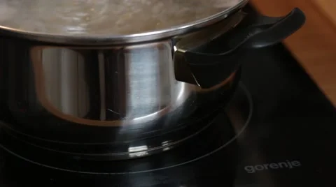 Heat field activated under pot with boiling Water Video stock 49655758