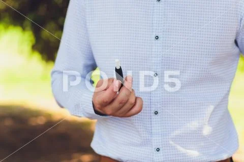 Heat-not-burn tobacco product technology. woman holding e-cigarette in his hand Stock Photos